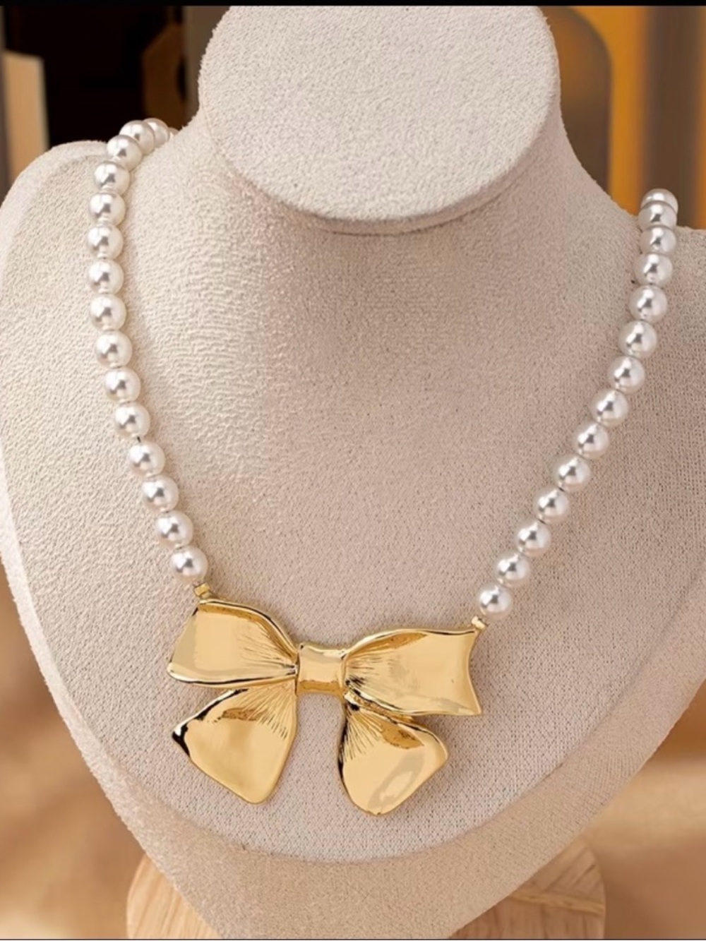 Goldtone Bow Faux Pearl Necklace - Picture 2 of 4